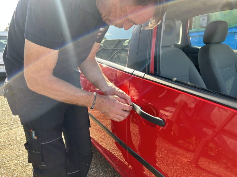 auto locksmith picking open a car