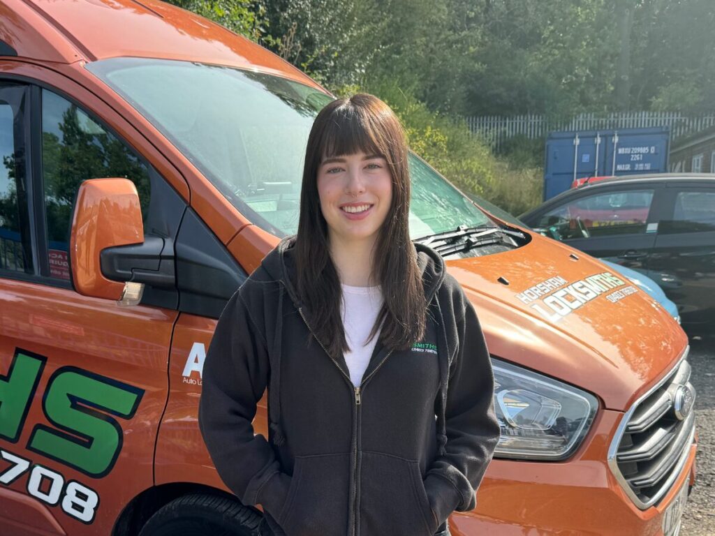 Caitlin standing in front of van