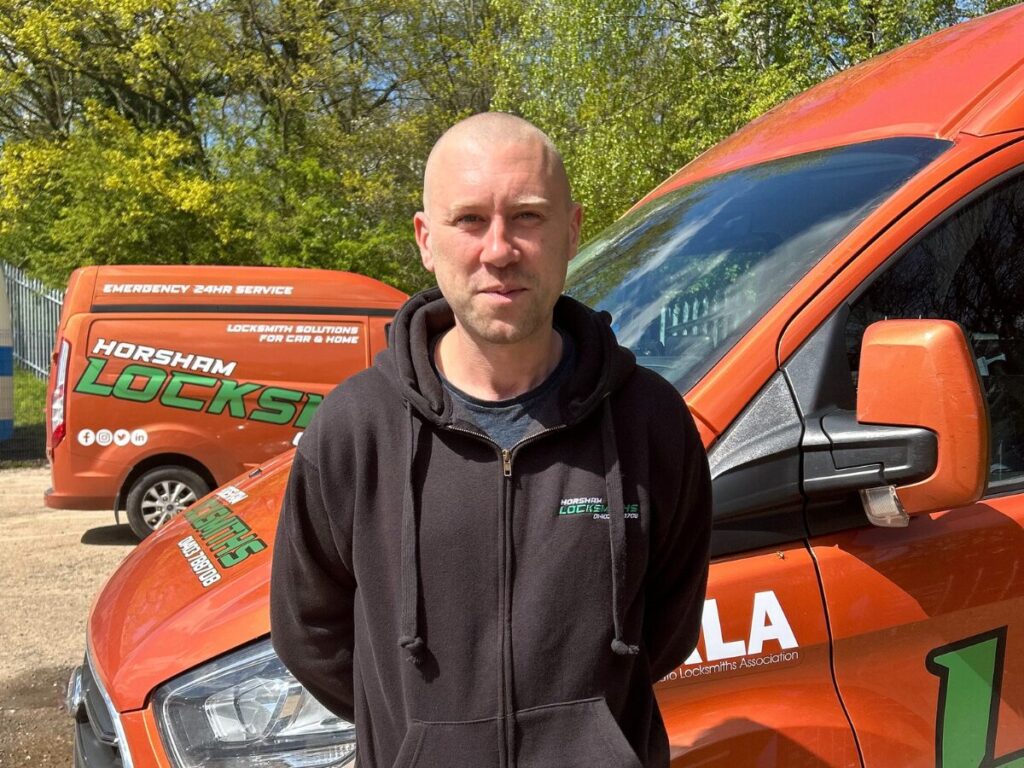 Laurence standing in front of van