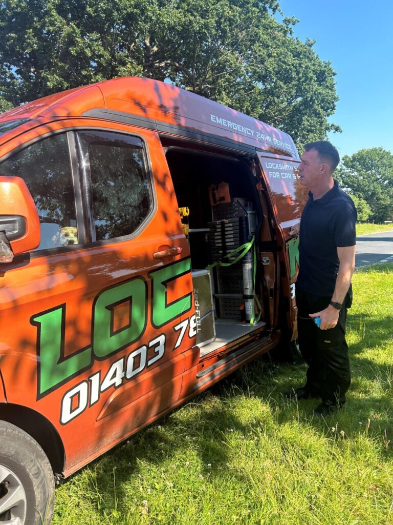 Locksmith standing by an open van